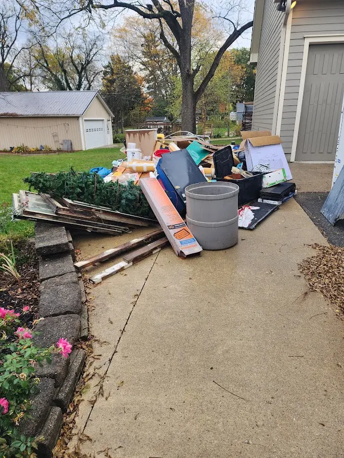 Dumpster being loaded with debris for Estate Cleanout Dumpster Rental in Suncrest